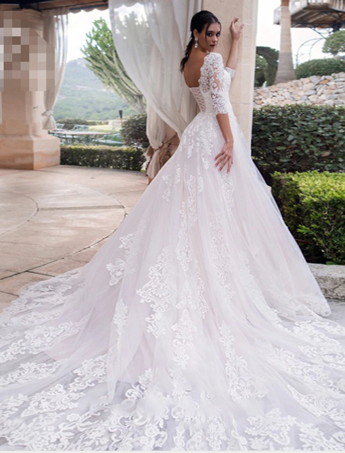 Close-up of delicate lace and applique details on the wedding dress.