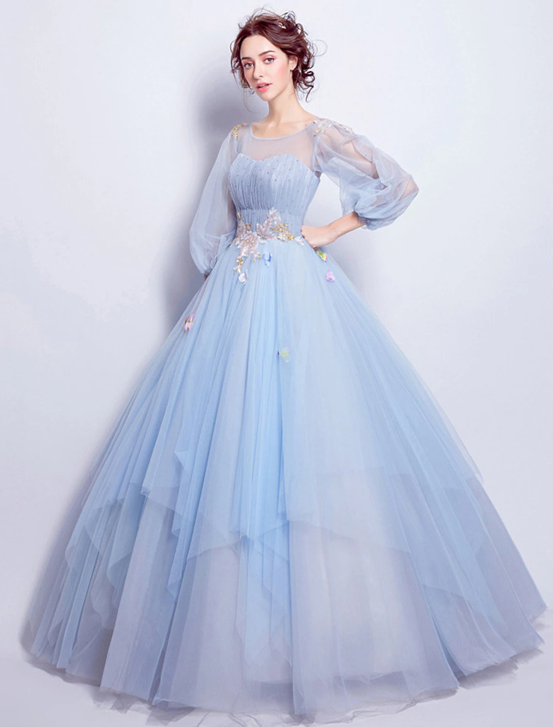 Elegant light-colored ball gown with illusion neckline and 3/4 sleeves.