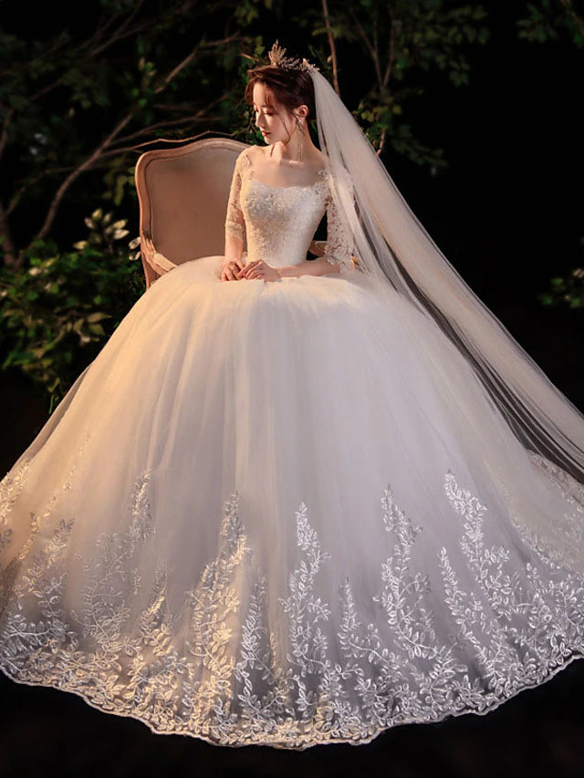 Side profile of the white ball gown, highlighting its voluminous skirt and elegant silhouette.