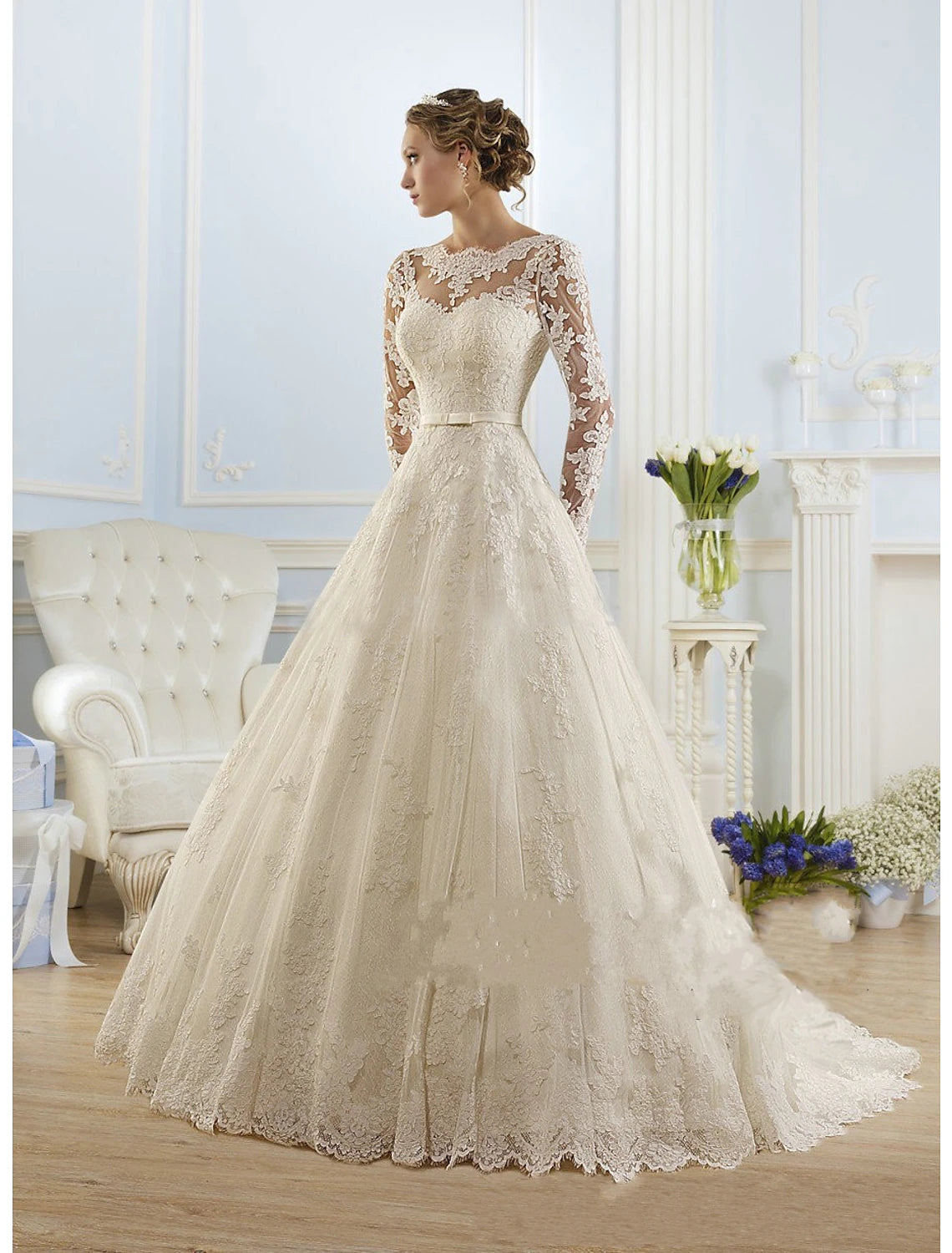 Elegant white ball gown wedding dress with long illusion lace sleeves and court train.