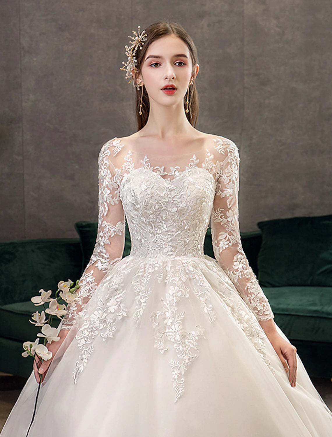 Close-up of lace appliques and pleats on a formal wedding dress.