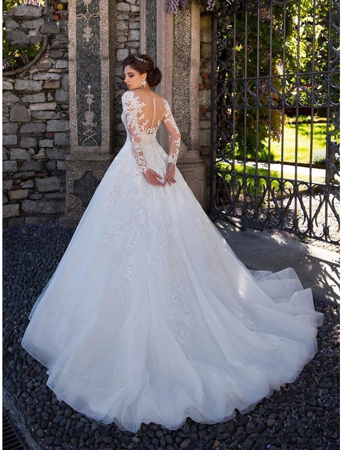 Side view of bridal ball gown showing lace details and court train.
