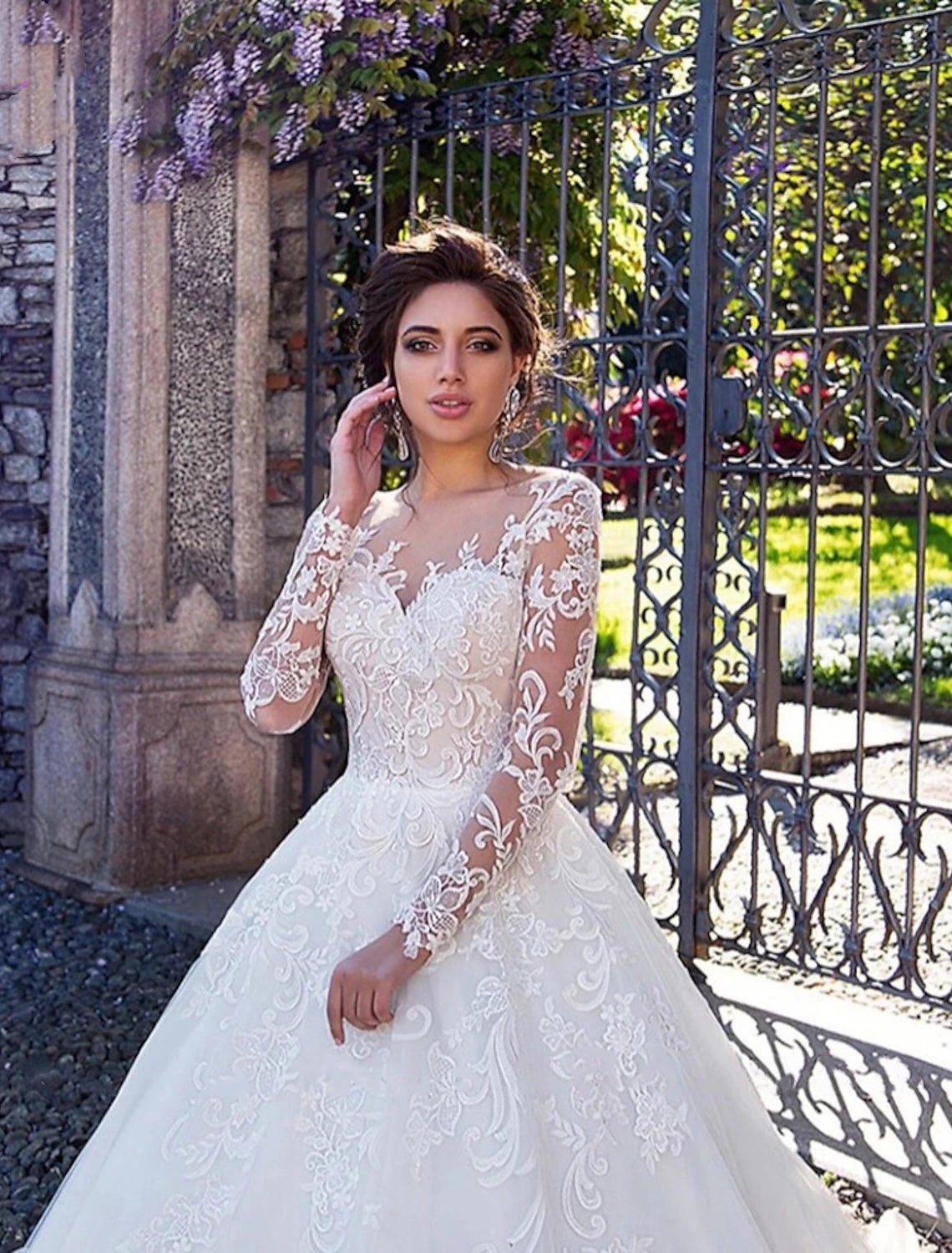 Close-up of illusion neckline and lace appliques on wedding dress bodice.