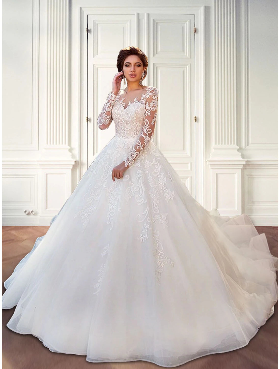 Full length view of a woman wearing a formal long sleeve bridal gown.