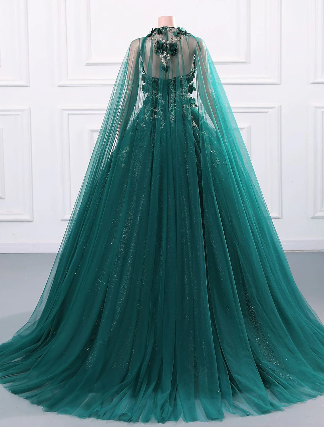 Back view of the quinceanera dress showing tulle and court train.
