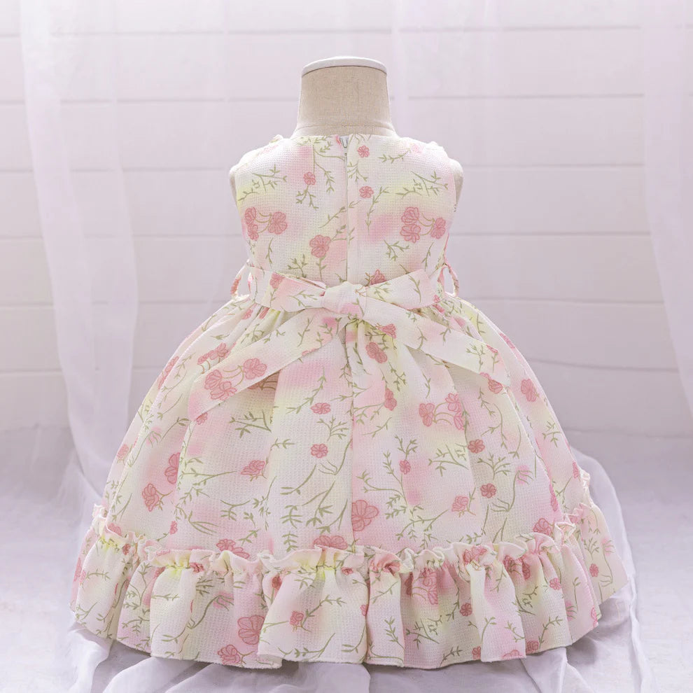 Close-up of the scoop neckline and ruffled details on the flower girl dress.