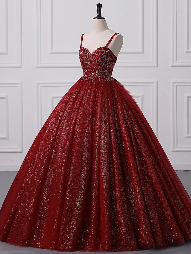 Elegant ball gown prom dress with spaghetti straps, lace, and beading appliques.