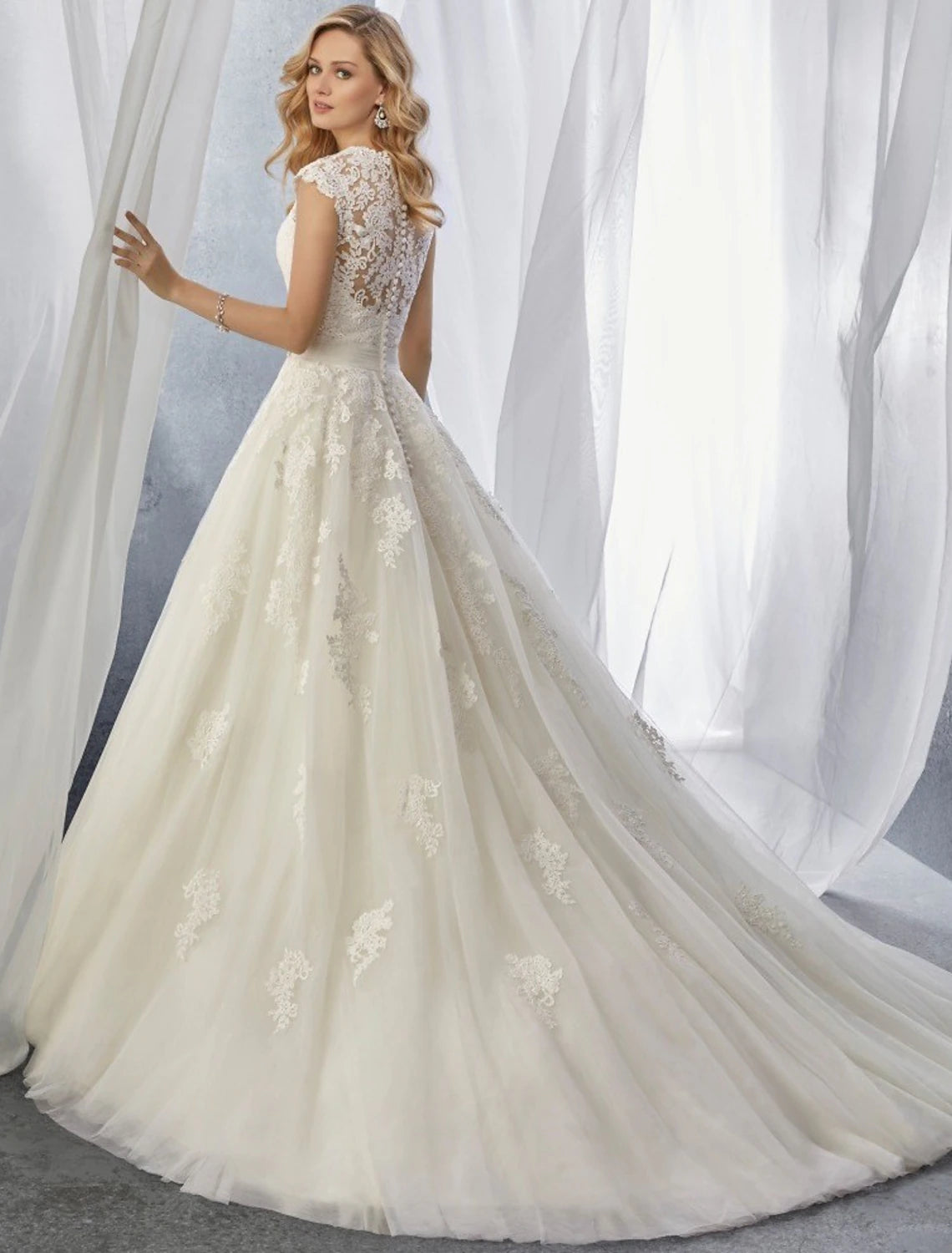 Side view of formal wedding dress featuring intricate lace details.