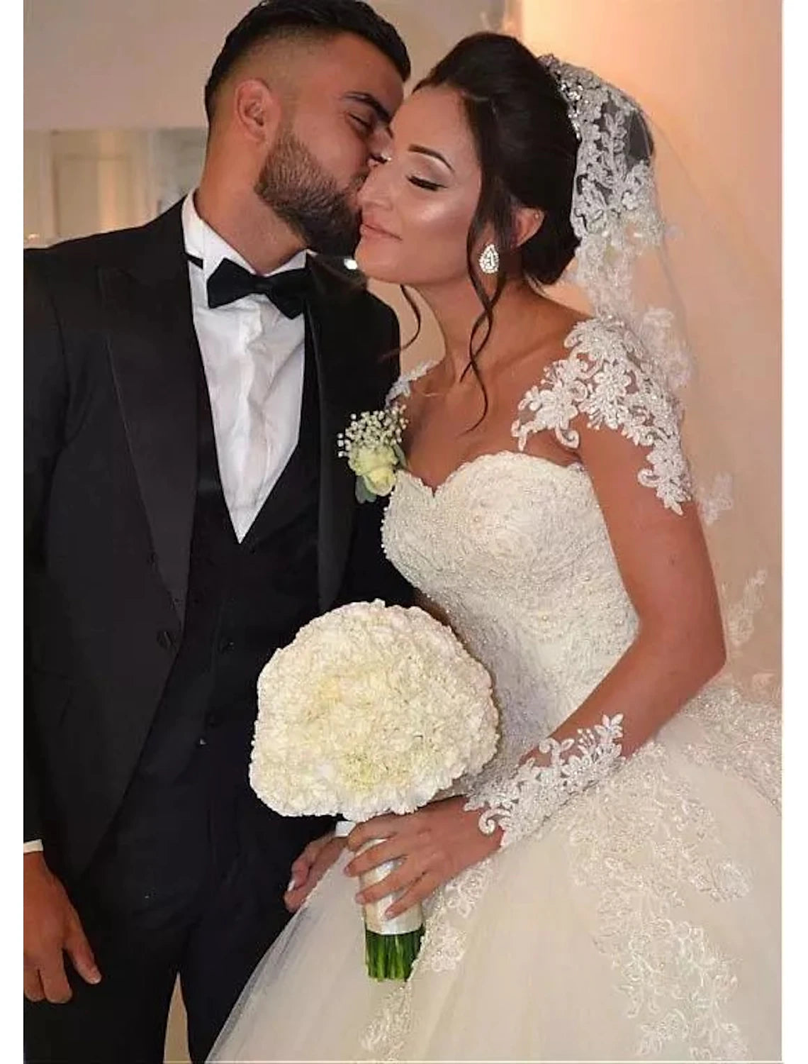 Side profile of the bride in the sweetheart long sleeve lace wedding dress.