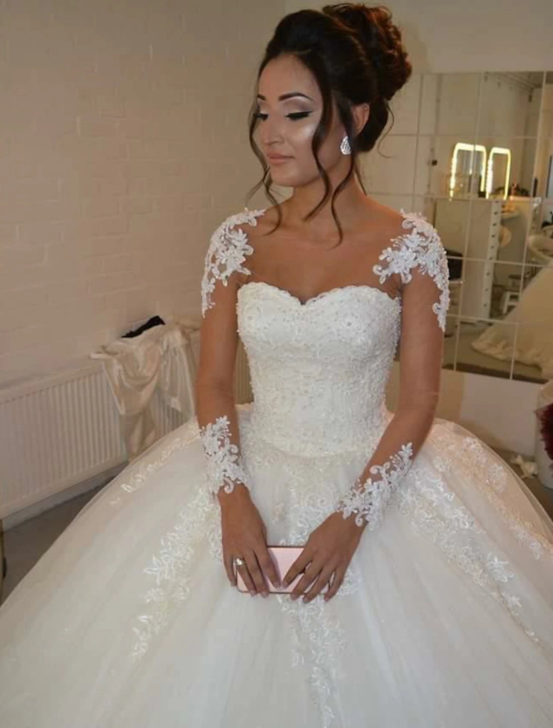 Full view of the elegant bridal gown, showcasing its flowing floor-length skirt.