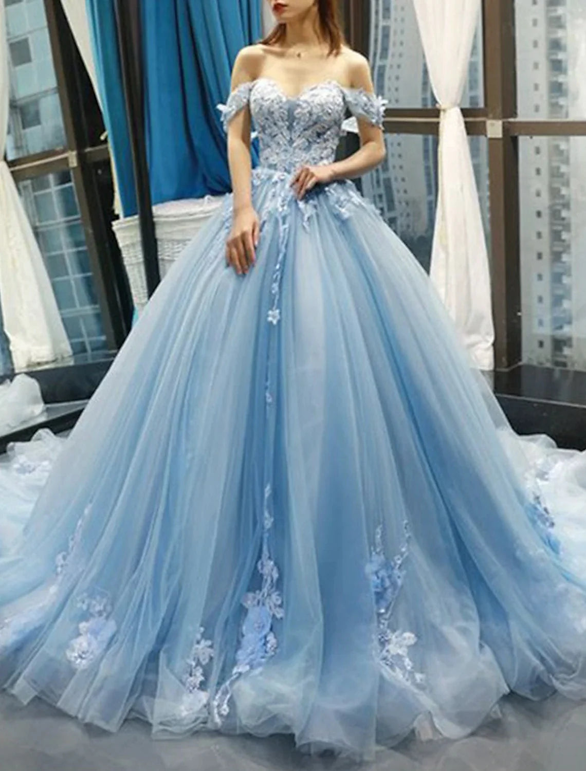 Ball gown with a sweetheart bodice and flowing skirt, suitable for special events.