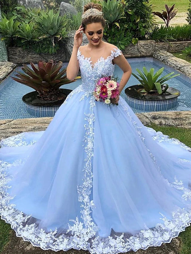 Woman in elegant white ball gown wedding dress with lace and appliques.