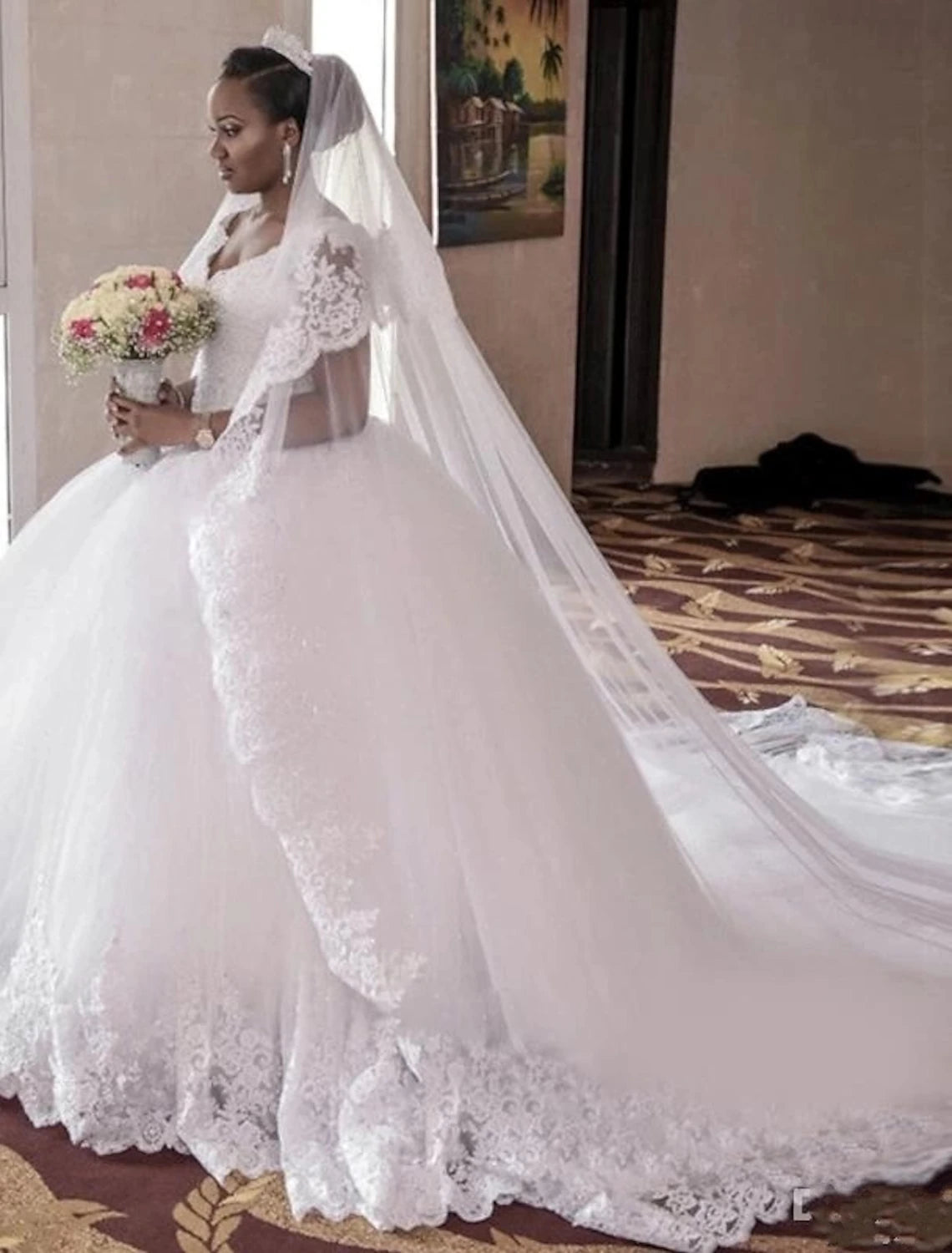 Elegant V-neck cap sleeve ball gown wedding dress with lace and beading, featuring a chapel train.