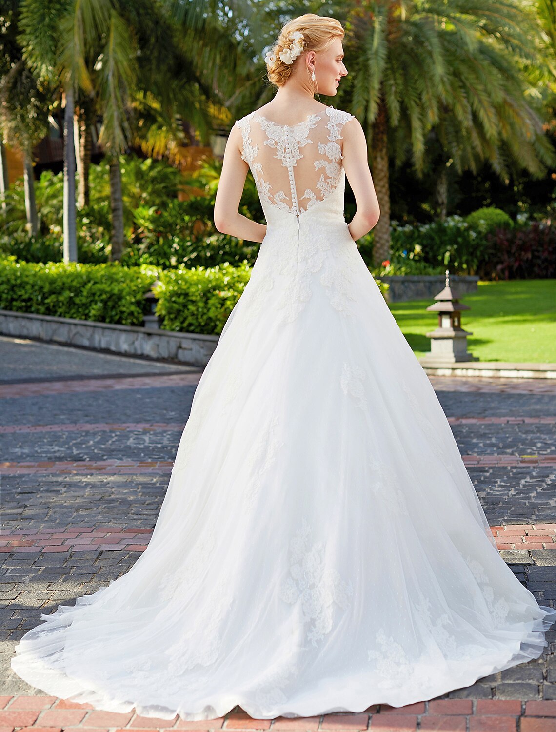 Close-up of lace appliques and V-neckline on wedding dress.