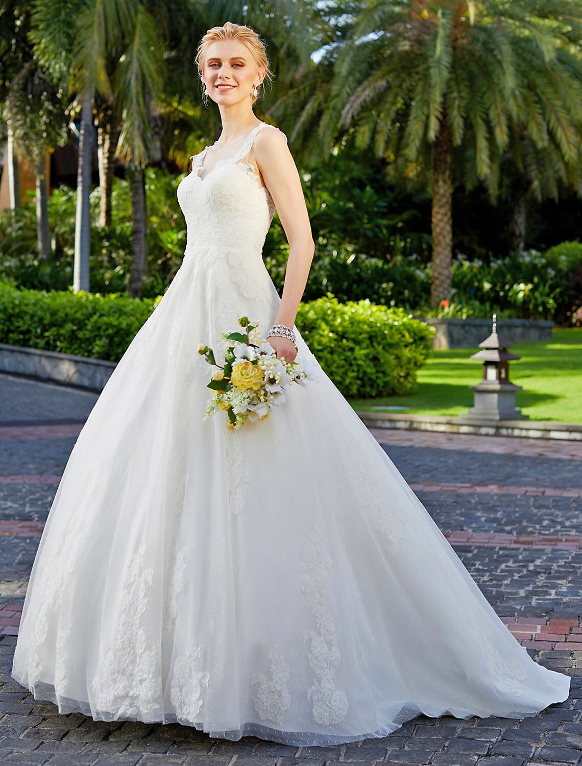 Side profile of a bride wearing a V-neck ball gown.