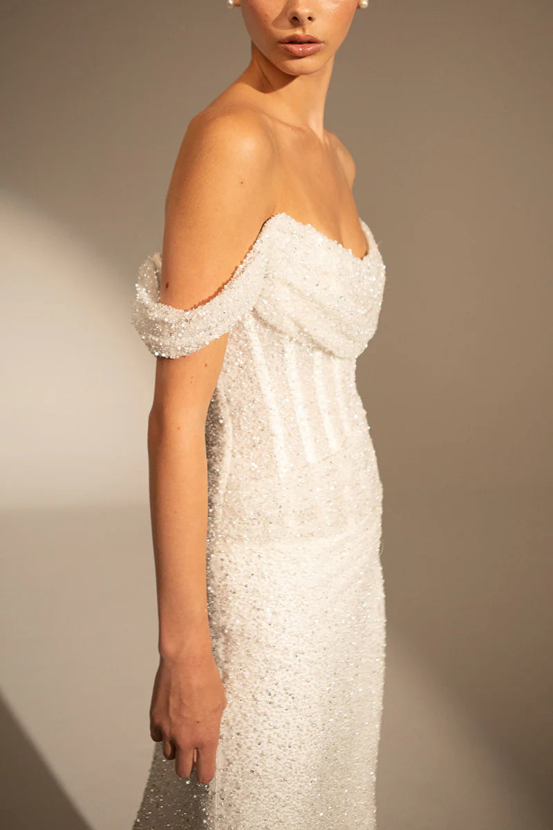 Close-up of the Bardot off-shoulder neckline on the wedding dress.