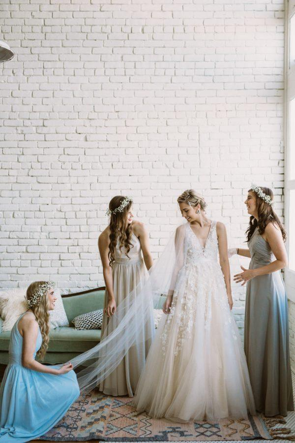 Back view of an ivory A-line wedding dress with delicate lace details.