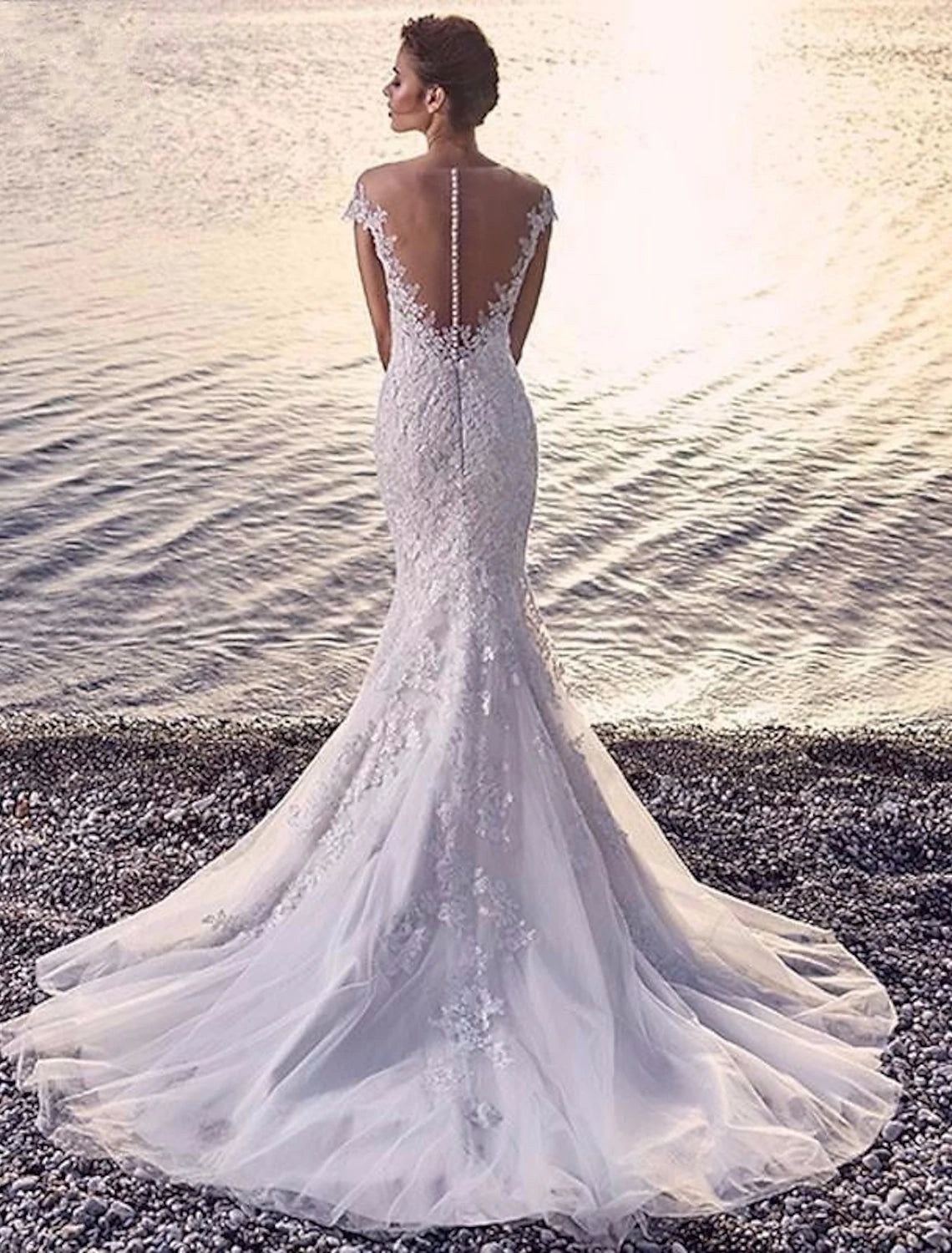 Back view of a Mermaid Trumpet bridal gown featuring a court train and intricate lace details.