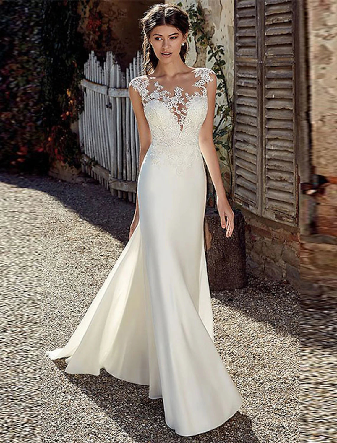 Elegant mermaid wedding dress with illusion neckline and cap sleeves.