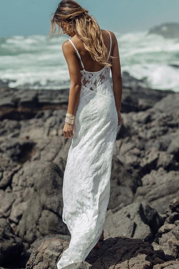 Full length view of a long lace sheath wedding dress.