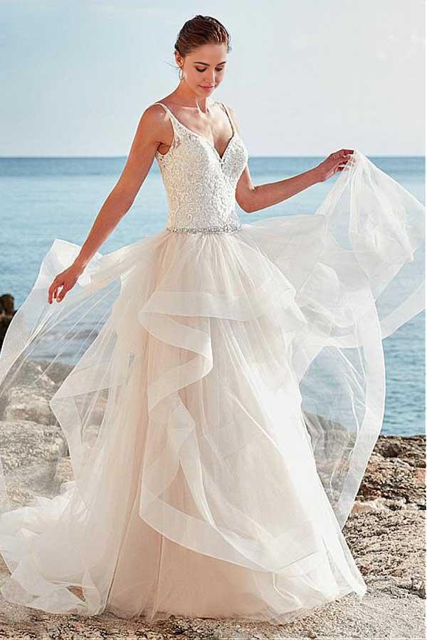 Elegant A-Line wedding dress with V-neck, spaghetti straps, and intricate beading.