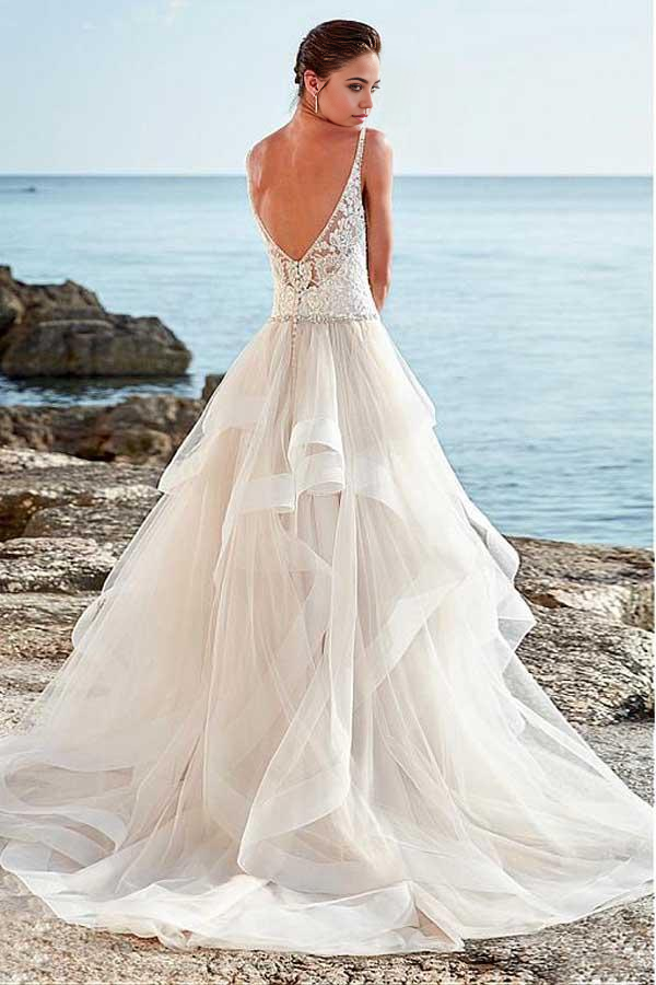 Close-up of the beaded details on an A-Line wedding dress with spaghetti straps.