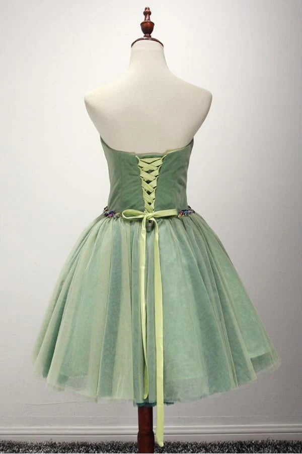 Close-up of the green A-line sweetheart short tulle homecoming dress with intricate beading.