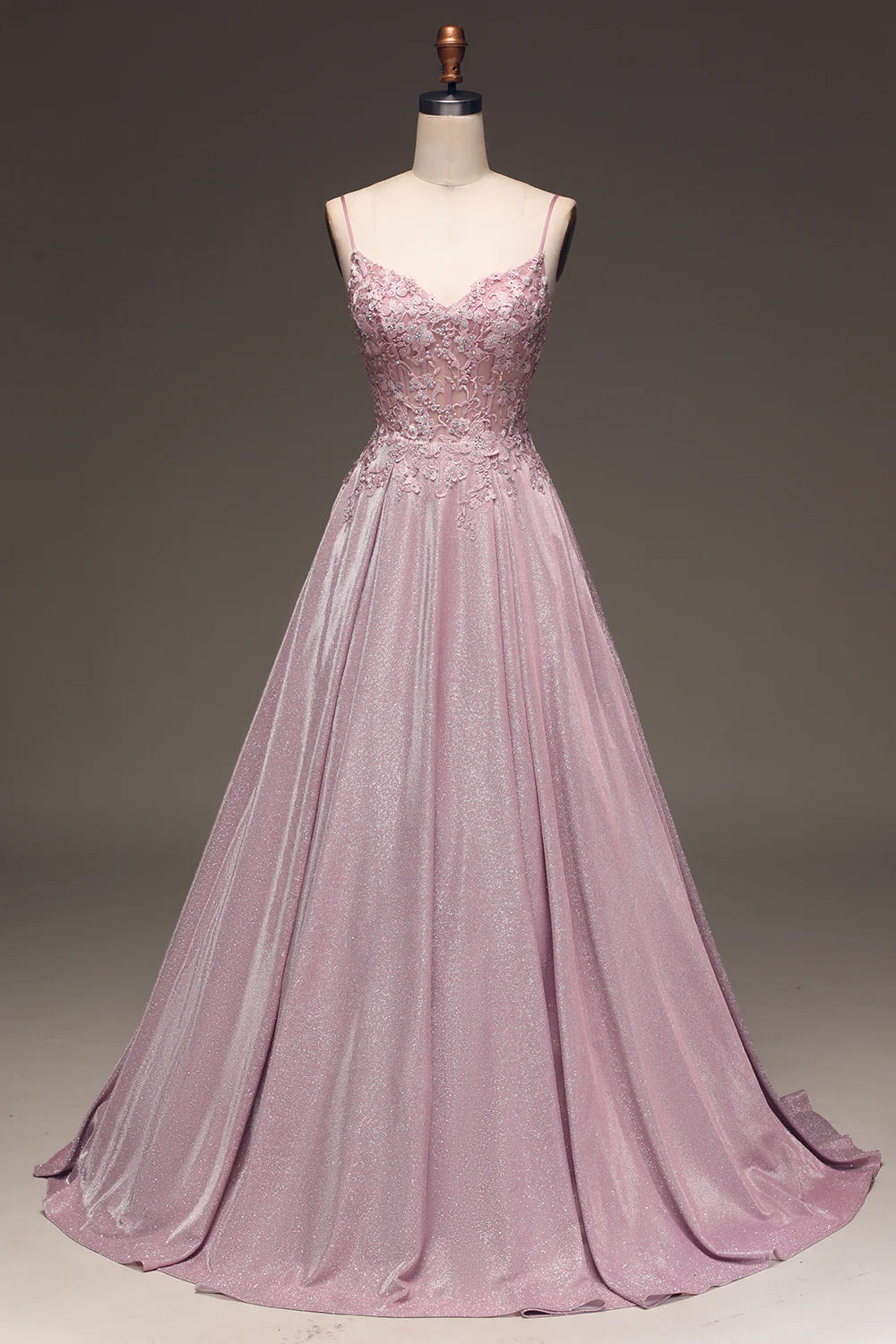 Front view of a blush beaded applique ball gown with spaghetti straps.