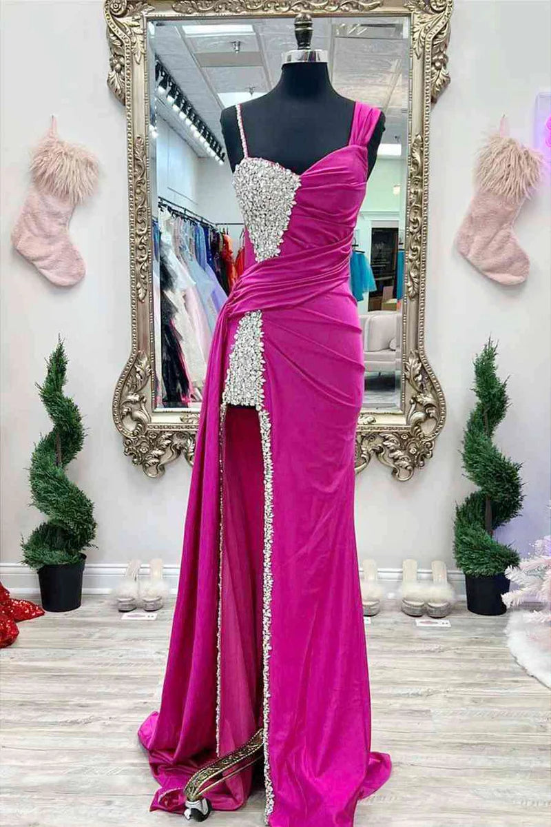 Woman in a beaded asymmetrical long prom dress, front view.