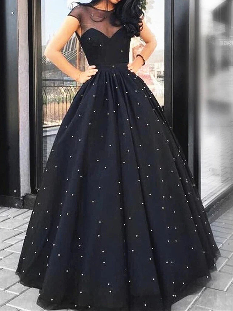 Long prom dress with cap sleeves, round neck, and intricate beading.