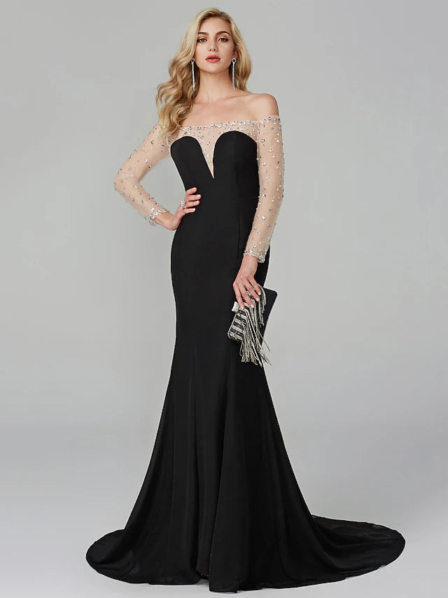 Model wearing an elegant beaded chiffon mermaid gown with off-shoulder long sleeves.
