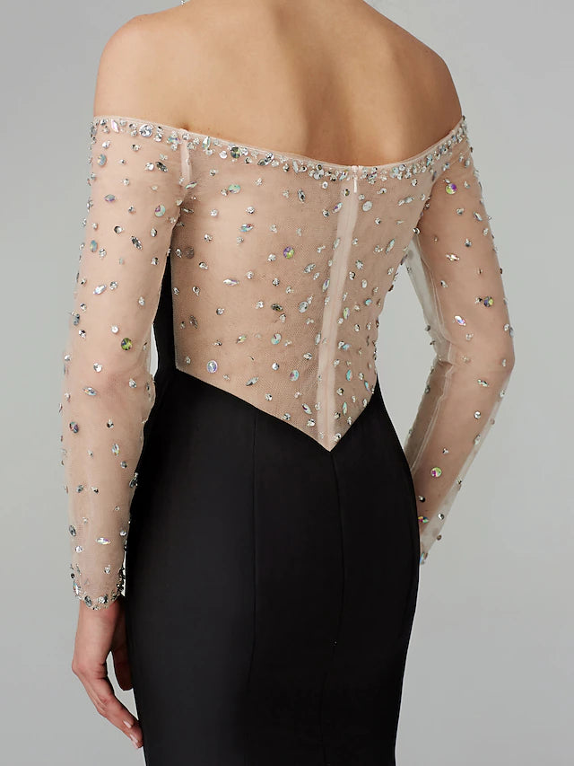 Side view of an elegant mermaid gown, showcasing the fitted silhouette and long sleeves.