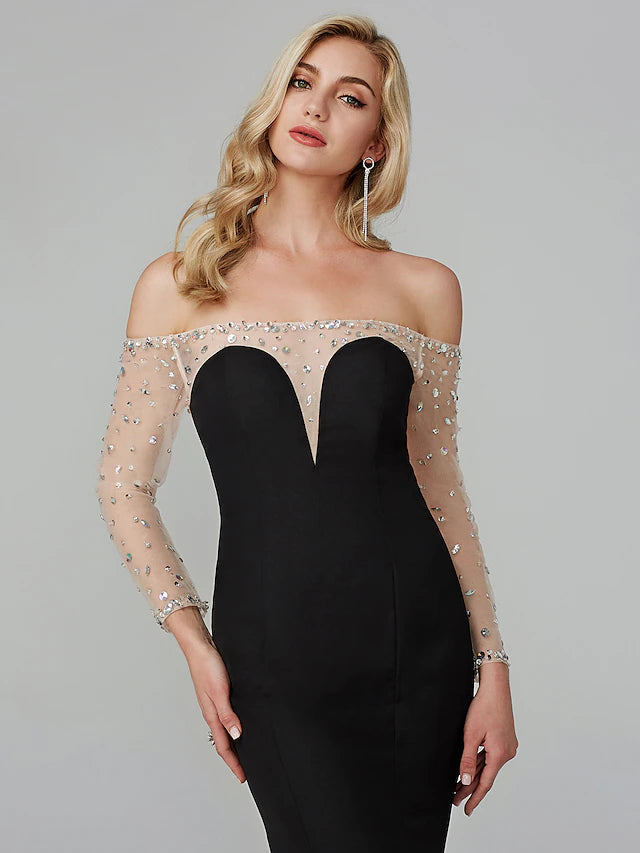 Model posing in a glamorous off-shoulder long-sleeve mermaid dress.