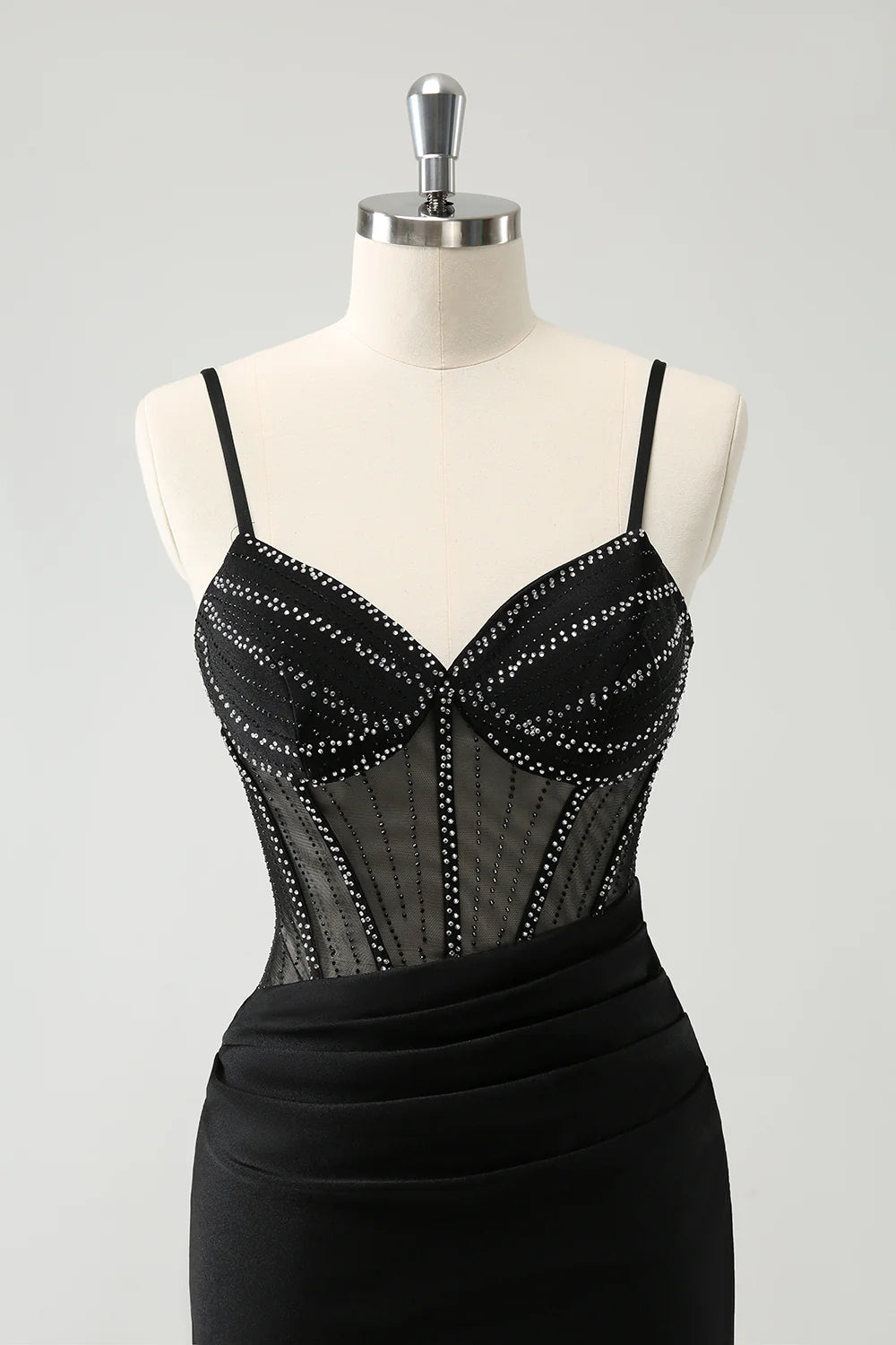 Model wearing a black short homecoming dress, front view.