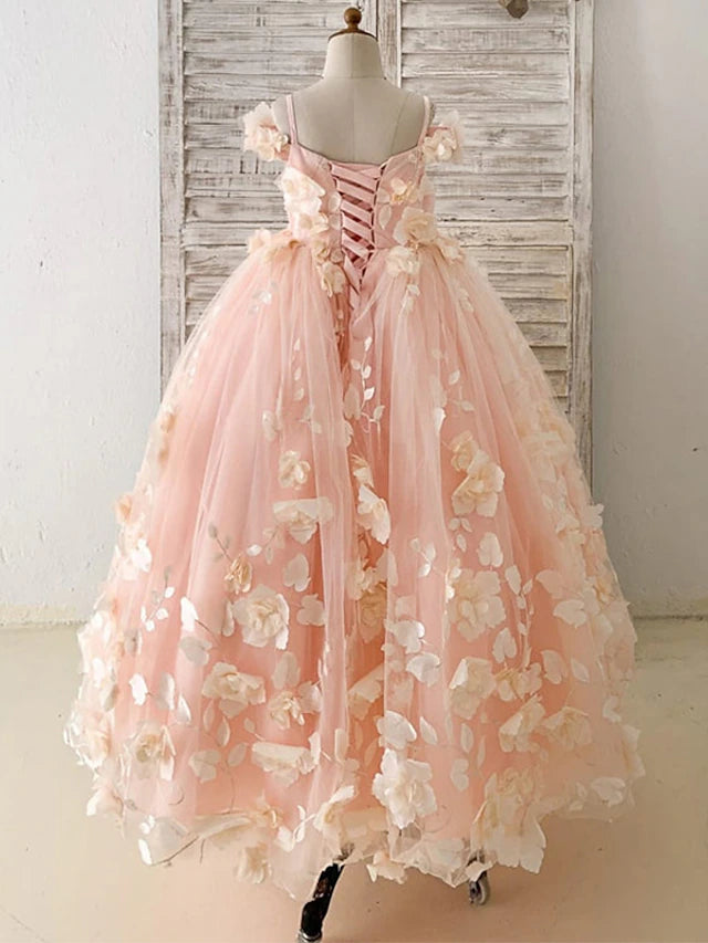 Detailed view of the bodice and floral appliques on the white princess dress.