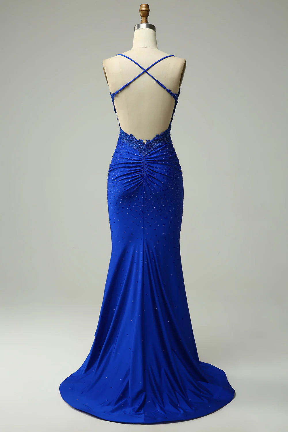 Back view of a woman wearing the long beaded halter mermaid gown.