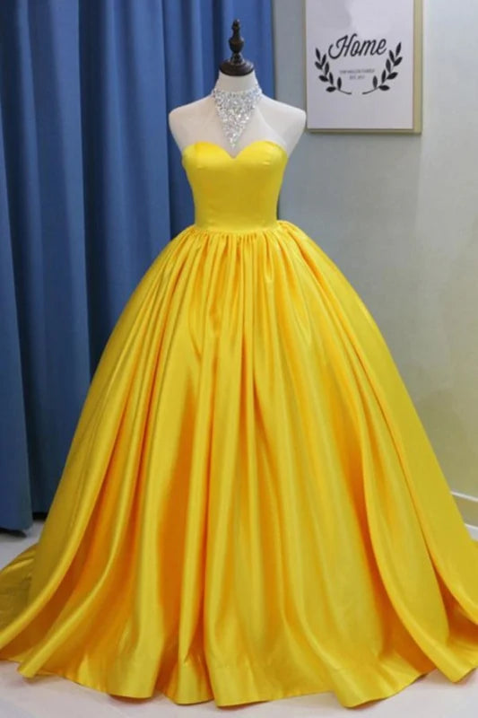 Full-length view of an elegant beaded halter neck ball gown.