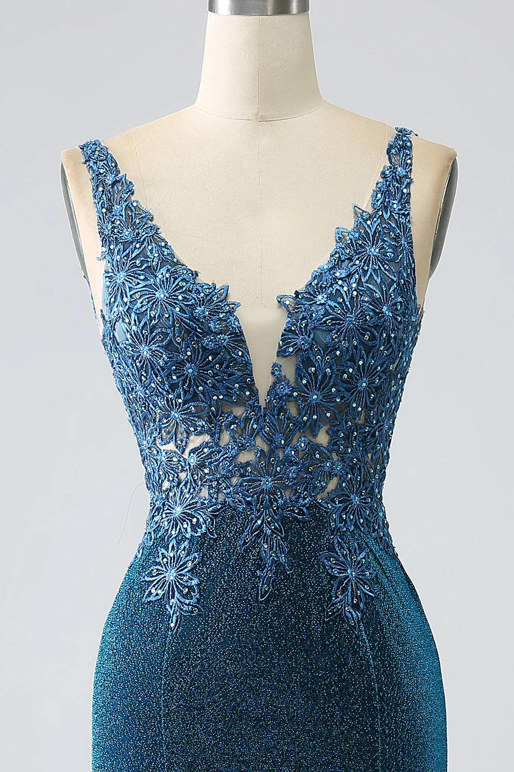 Side profile of the dark blue mermaid dress, showcasing its silhouette.