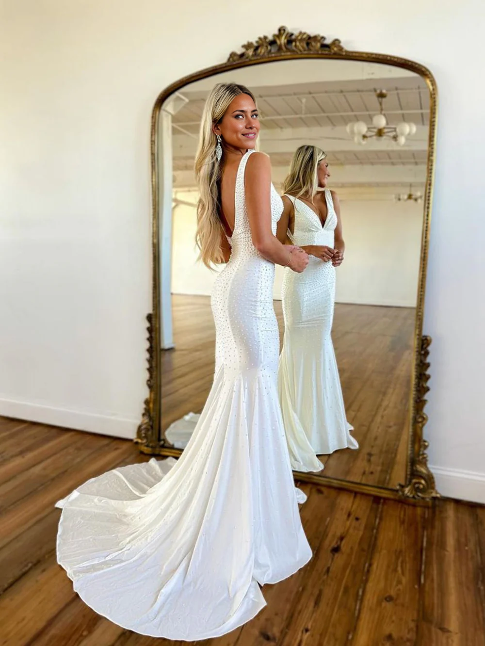 Back view of the mermaid beaded deep V-neck satin long prom dress, showcasing the flowing train.