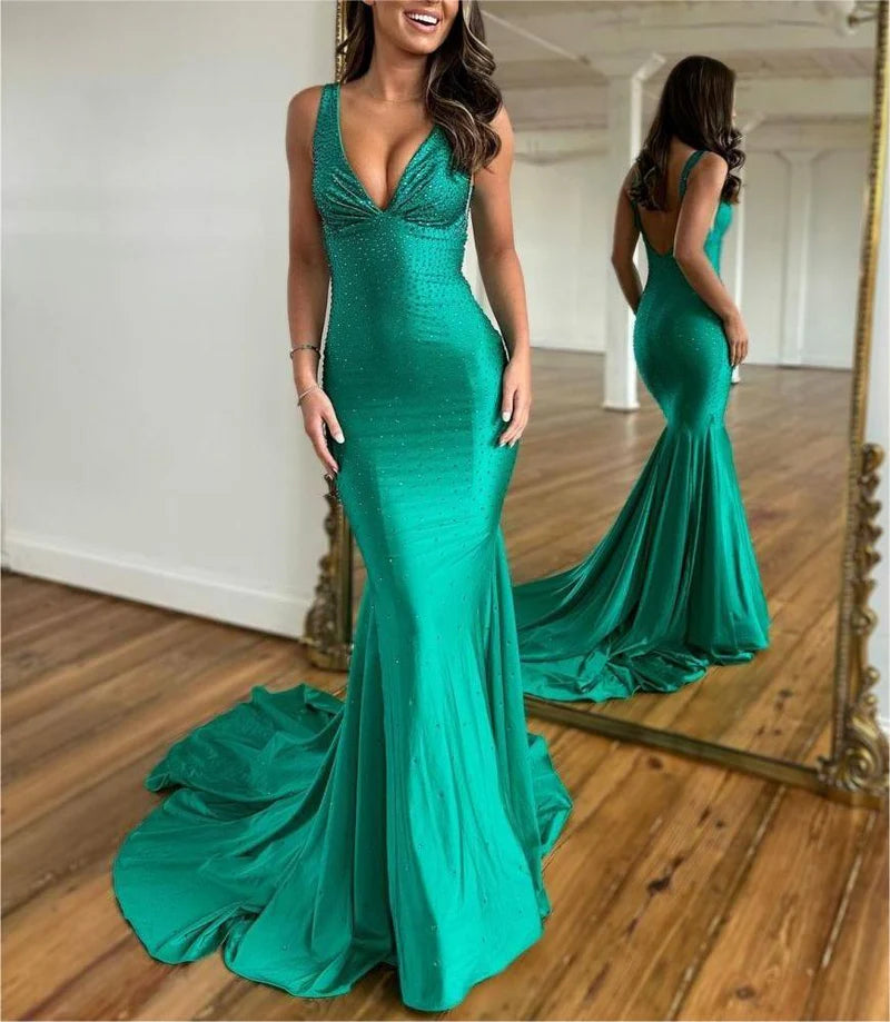 Side profile of a woman posing in the elegant mermaid satin prom dress.