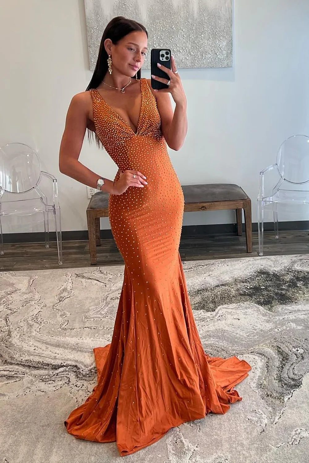 Detailed view of the luxurious satin fabric and mermaid skirt of the prom dress.
