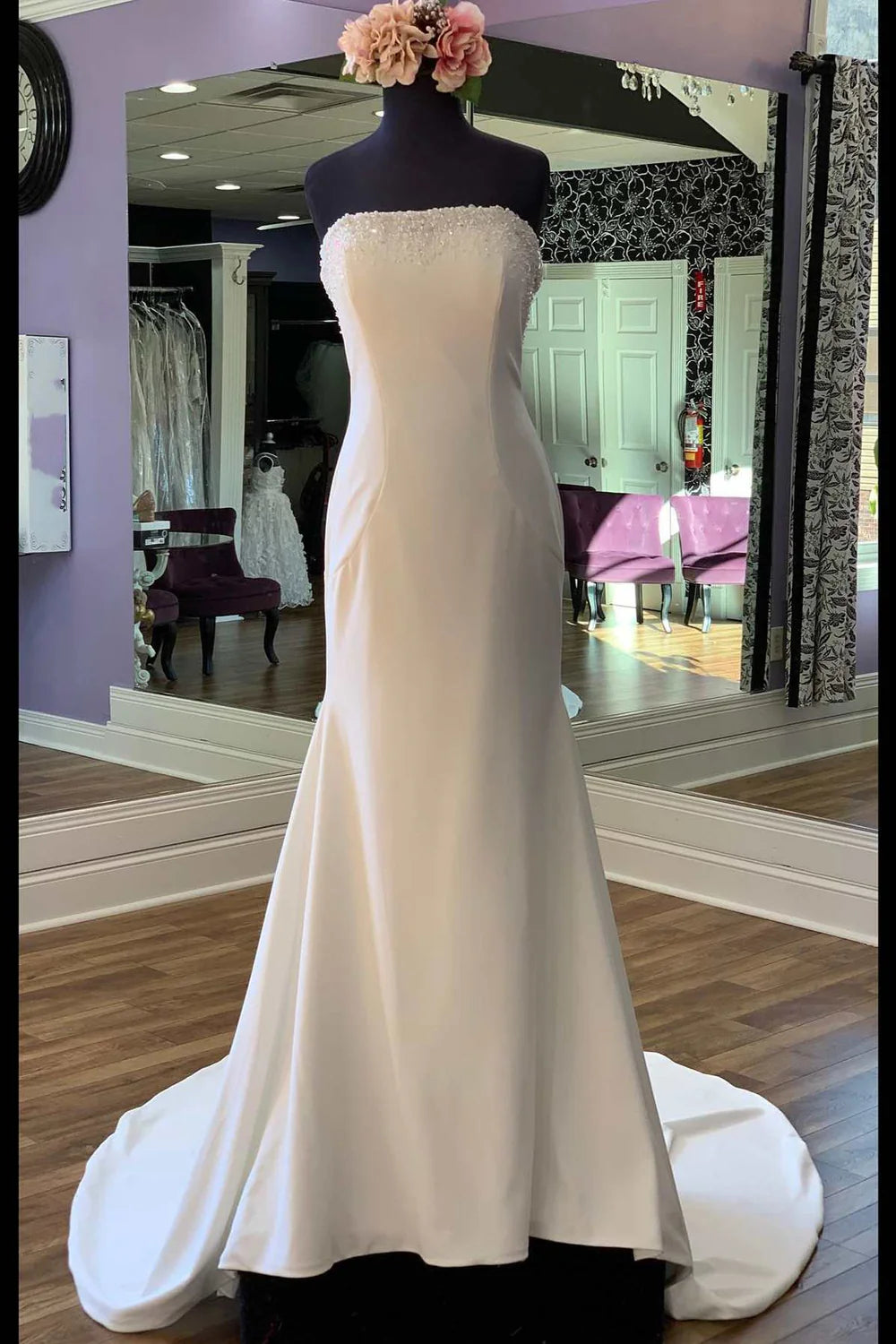 Elegant white mermaid bridal gown with intricate beading.
