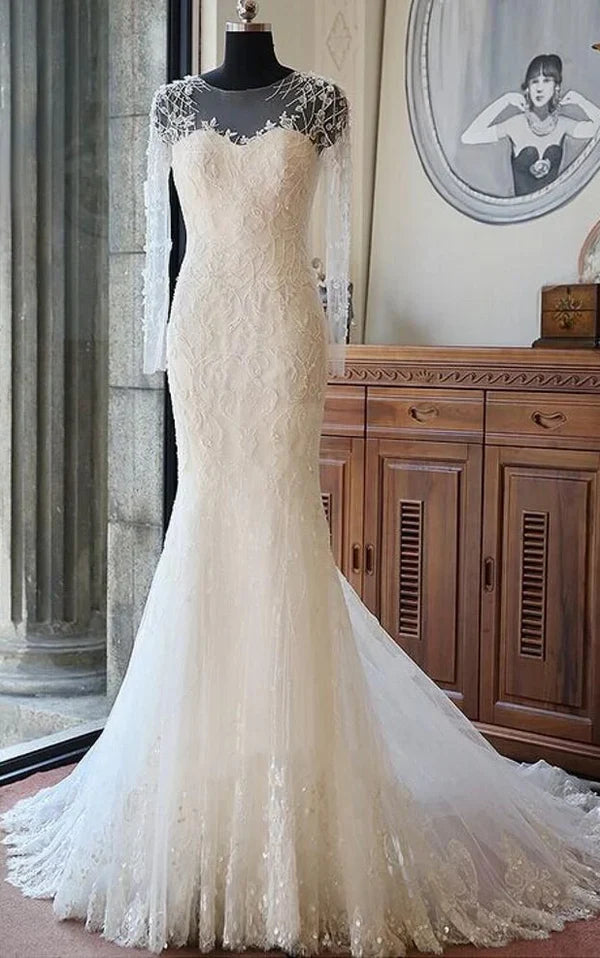 Elegant mermaid wedding dress with intricate beading and a chapel train.