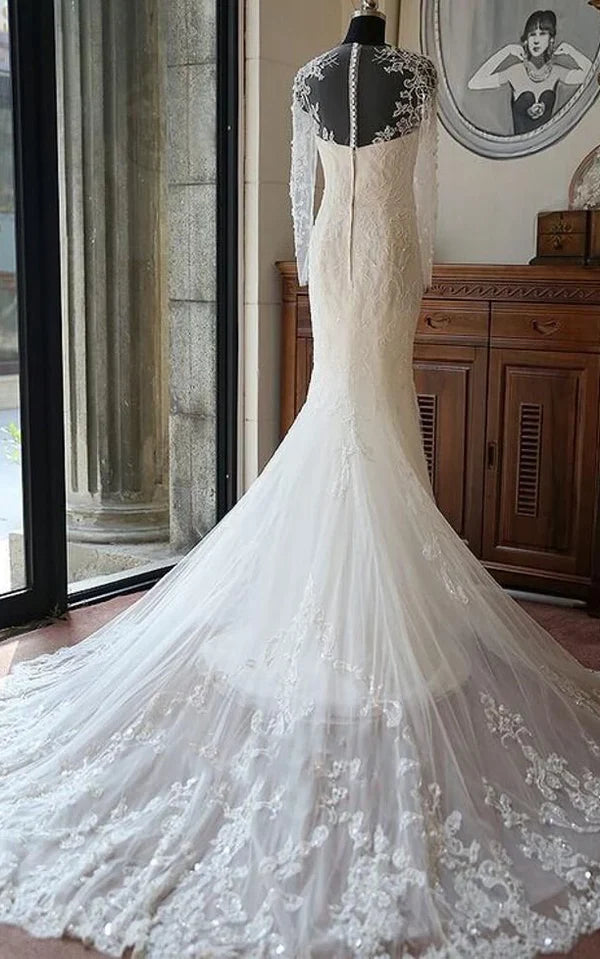 Back view of a beaded mermaid wedding gown featuring a flowing chapel train.