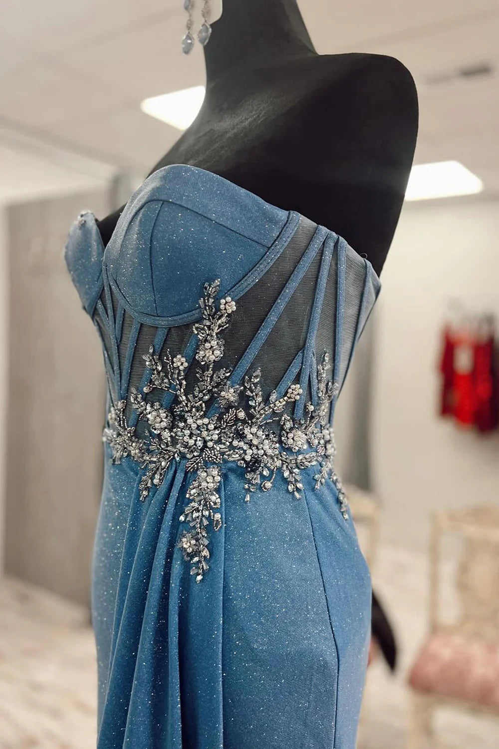 Back view of the long blue mermaid dress, showcasing its elegant silhouette.