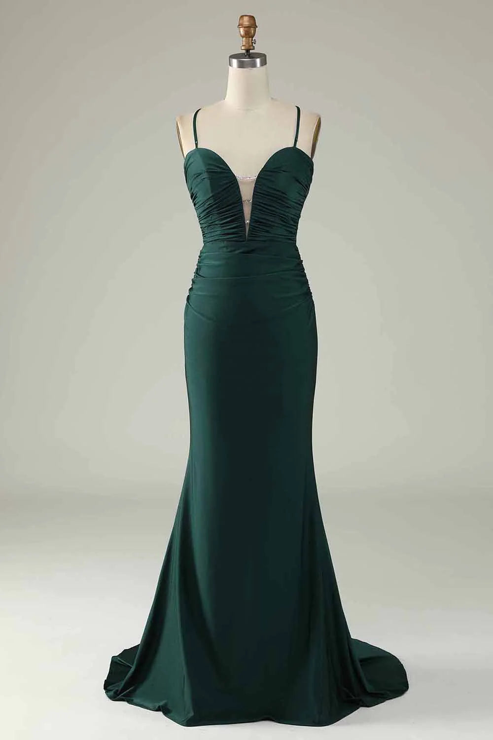 Woman wearing a dark green beaded mermaid V-neck long prom dress, front view.