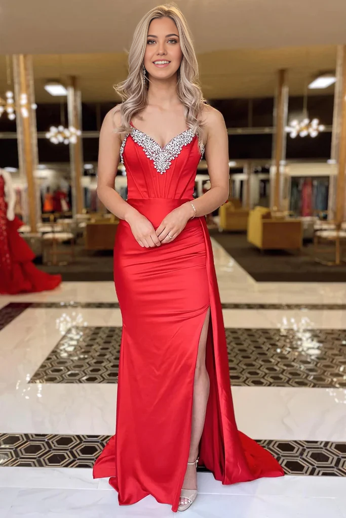 Full length view of a woman posing in a mermaid prom dress.