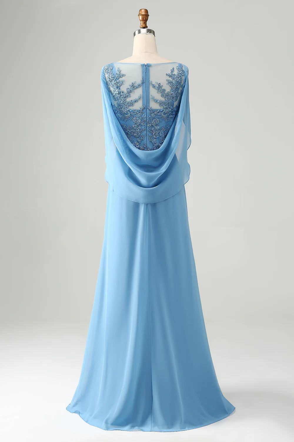 Side view of a woman in a blue mermaid V-neck dress, showcasing the beaded appliques and flowing silhouette.