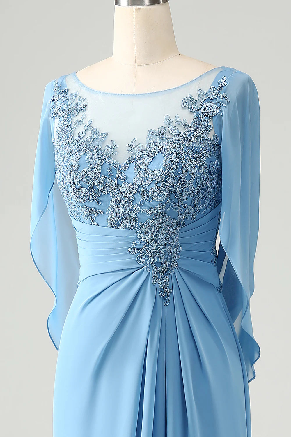 Close-up of the intricate beading and appliques on the blue mermaid dress.