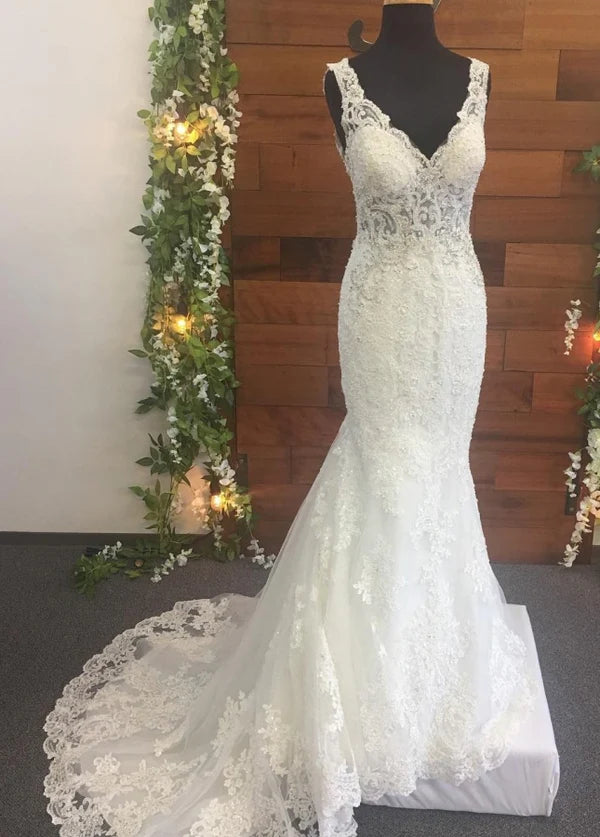 Elegant white beaded V-neck mermaid wedding gown.